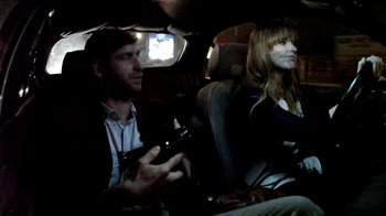 Movie still from “V/H/S/2” (2013), directed by Timo Tjahjanto – A man and a woman sitting in the back of a car; Medium shot, Over the shoulder angle