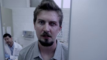 Movie still from “V/H/S/2” (2013), directed by Timo Tjahjanto – A person in a mirror; Close Up shot, Over the shoulder angle