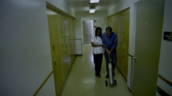 Movie still from “V/H/S/2” (2013), directed by Timo Tjahjanto – A man and a woman are in a hallway; Wide shot, High angle