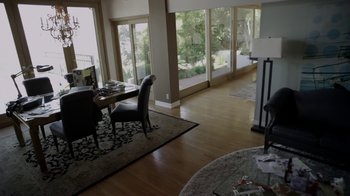Movie still from “V/H/S/2” (2013), directed by Timo Tjahjanto – A dining room table and chairs in a living room; Wide shot, High angle
