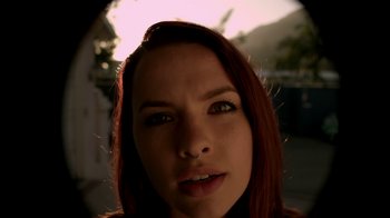 Movie still from “V/H/S/2” (2013), directed by Timo Tjahjanto – A woman with red hair looking at the camera; Extreme Close Up shot, Low angle