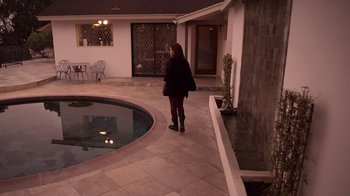 Movie still from “V/H/S/2” (2013), directed by Timo Tjahjanto – A woman standing in front of a swimming pool; Extreme Wide shot, High angle