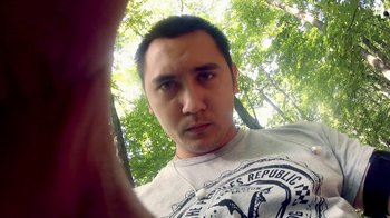 Movie still from “V/H/S/2” (2013), directed by Timo Tjahjanto – A person taking a selfie in a forest; Close Up shot, Overhead angle