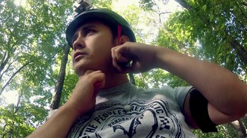 Movie still from “V/H/S/2” (2013), directed by Timo Tjahjanto – A young man wearing a green helmet while listening to music; Close Up shot, Low angle