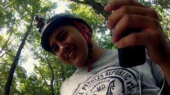 Movie still from “V/H/S/2” (2013), directed by Timo Tjahjanto – A young man wearing a helmet and holding a cell phone in his hand; Close Up shot, Low angle