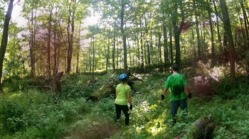 Movie still from “V/H/S/2” (2013), directed by Timo Tjahjanto – A man and a woman are walking through the woods; Extreme Wide shot, Over the shoulder angle