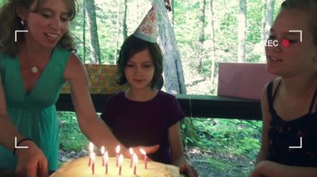 Movie still from “V/H/S/2” (2013), directed by Timo Tjahjanto – A girl in a birthday hat is blowing out the candles on a cake; Medium shot, High angle