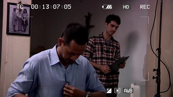 Movie still from “V/H/S/2” (2013), directed by Timo Tjahjanto – Two young men standing next to each other in a room; Medium shot, Over the shoulder angle