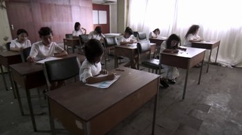 Movie still from “V/H/S/2” (2013), directed by Timo Tjahjanto – A group of children sitting at a table in a classroom; Wide shot, High angle