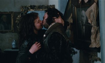 Movie still from “Vagabond” (1985), directed by Agnès Varda – A man and a woman are kissing in a room; Close Up shot, Over the shoulder angle