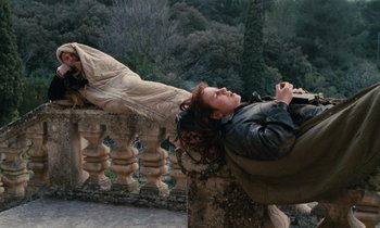 Movie still from “Vagabond” (1985), directed by Agnès Varda – A woman laying on top of a railing next to a railing; Wide shot, High angle
