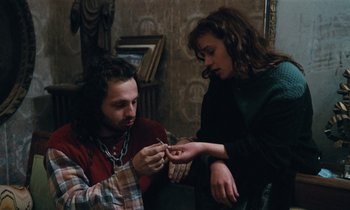 Movie still from “Vagabond” (1985), directed by Agnès Varda – A man and a woman looking at each other's nails; Close Up shot, High angle