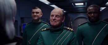 Movie still from “Valerian and the City of a Thousand Planets” (2017), directed by Luc Besson – A man in a green suit and a man in a black suit; Medium shot, Over the shoulder angle