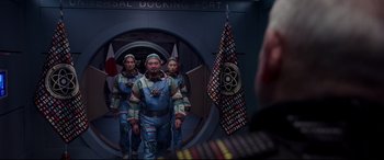 Movie still from “Valerian and the City of a Thousand Planets” (2017), directed by Luc Besson – A group of people standing next to each other in space suits; Medium shot, Over the shoulder angle