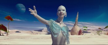 Movie still from “Valerian and the City of a Thousand Planets” (2017), directed by Luc Besson – A woman in a blue dress standing in the desert; Medium shot, Low angle