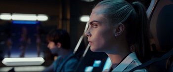 Movie still from “Valerian and the City of a Thousand Planets” (2017), directed by Luc Besson – A person wearing a white shirt; Close Up shot, Over the shoulder angle