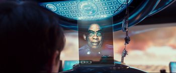Movie still from “Valerian and the City of a Thousand Planets” (2017), directed by Luc Besson – A man with glasses is looking at a computer screen; Close Up shot, Over the shoulder angle