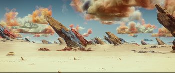 Movie still from “Valerian and the City of a Thousand Planets” (2017), directed by Luc Besson – An image of a desert with rocks and clouds in the sky; Extreme Wide shot, High angle