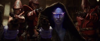 Movie still from “Valerian and the City of a Thousand Planets” (2017), directed by Luc Besson – A woman with a gun in her hand and a man with a gun in the background; Close Up shot, Over the shoulder angle