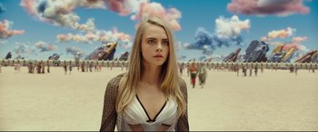 Movie still from “Valerian and the City of a Thousand Planets” (2017), directed by Luc Besson – A woman standing in front of a group of people; Medium shot, Over the shoulder angle