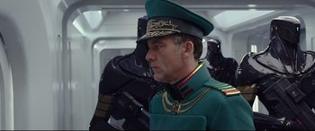 Movie still from “Valerian and the City of a Thousand Planets” (2017), directed by Luc Besson – A man in a military uniform next to another man in a space suit; Close Up shot, Low angle