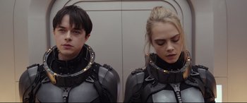 Movie still from “Valerian and the City of a Thousand Planets” (2017), directed by Luc Besson – A man and a woman wearing futuristic armor; Close Up shot, Low angle