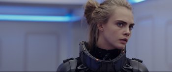 Movie still from “Valerian and the City of a Thousand Planets” (2017), directed by Luc Besson – A person wearing a suit; Close Up shot, Over the shoulder angle