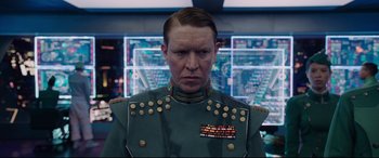 Movie still from “Valerian and the City of a Thousand Planets” (2017), directed by Luc Besson – A man in a uniform is standing in front of a monitor; Close Up shot, Low angle