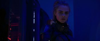 Movie still from “Valerian and the City of a Thousand Planets” (2017), directed by Luc Besson – A woman in a futuristic costume standing next to a building; Close Up shot, Low angle