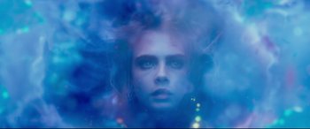 Movie still from “Valerian and the City of a Thousand Planets” (2017), directed by Luc Besson – A woman with blue hair is looking at the camera; Close Up shot, Overhead angle