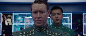 Movie still from “Valerian and the City of a Thousand Planets” (2017), directed by Luc Besson – A man in a military uniform standing next to another man in a military uniform; Close Up shot, Over the shoulder angle