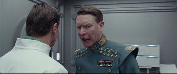 Movie still from “Valerian and the City of a Thousand Planets” (2017), directed by Luc Besson – A man in a military uniform talking to another man; Close Up shot, Over the shoulder angle