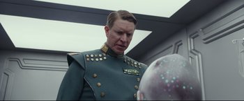 Movie still from “Valerian and the City of a Thousand Planets” (2017), directed by Luc Besson – A man in a military uniform looking at another man in a helmet; Close Up shot, Over the shoulder angle