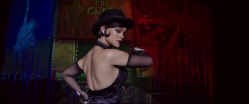 Movie still from “Valerian and the City of a Thousand Planets” (2017), directed by Luc Besson – A woman in a black dress and a black hat; Medium shot, Low angle