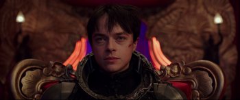 Movie still from “Valerian and the City of a Thousand Planets” (2017), directed by Luc Besson – A young man in a black suit with red paint on his face; Close Up shot, Low angle