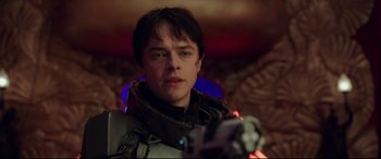 Movie still from “Valerian and the City of a Thousand Planets” (2017), directed by Luc Besson – A young man is holding a video game controller; Close Up shot, Over the shoulder angle
