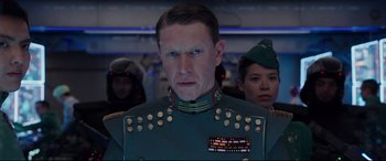 Movie still from “Valerian and the City of a Thousand Planets” (2017), directed by Luc Besson – A man in a military uniform is standing in front of a group of people; Close Up shot, Low angle