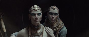 Movie still from “Valerian and the City of a Thousand Planets” (2017), directed by Luc Besson – A couple of people that are standing up in the dark; Close Up shot, Low angle