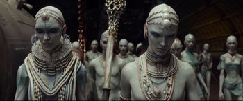Movie still from “Valerian and the City of a Thousand Planets” (2017), directed by Luc Besson – A group of people in costume are standing in a row; Medium shot, High angle
