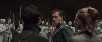Movie still from “Valerian and the City of a Thousand Planets” (2017), directed by Luc Besson – A man in a military uniform talking to another man; Medium shot, Over the shoulder angle