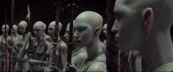 Movie still from “Valerian and the City of a Thousand Planets” (2017), directed by Luc Besson – A group of people that are standing in a room together; Medium shot, Low angle