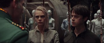 Movie still from “Valerian and the City of a Thousand Planets” (2017), directed by Luc Besson – Two women standing next to each other in front of a group of mannequins; Close Up shot, Over the shoulder angle