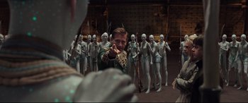 Movie still from “Valerian and the City of a Thousand Planets” (2017), directed by Luc Besson – A man pointing to a group of people in a room; Medium shot, Over the shoulder angle