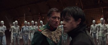 Movie still from “Valerian and the City of a Thousand Planets” (2017), directed by Luc Besson – A man in a military uniform standing next to another man; Medium shot, Over the shoulder angle