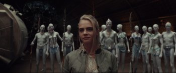 Movie still from “Valerian and the City of a Thousand Planets” (2017), directed by Luc Besson – A woman standing in front of a group of people; Medium shot, Over the shoulder angle