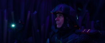 Movie still from “Valerian and the City of a Thousand Planets” (2017), directed by Luc Besson – A man wearing a helmet is looking into the distance; Close Up shot, Low angle