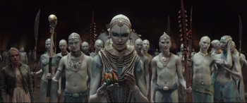 Movie still from “Valerian and the City of a Thousand Planets” (2017), directed by Luc Besson – A group of people with painted faces standing in a row; Wide shot, High angle