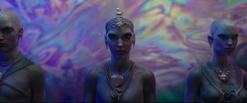 Movie still from “Valerian and the City of a Thousand Planets” (2017), directed by Luc Besson – A woman with blue skin is wearing a necklace; Medium shot, Low angle