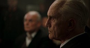 Movie still from “Valkyrie” (2008), directed by Bryan Singer – Two older men in business suits looking off into the distance; Close Up shot, Low angle