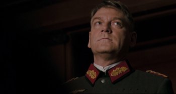 Movie still from “Valkyrie” (2008), directed by Bryan Singer – A person wearing a military uniform; Close Up shot, Low angle